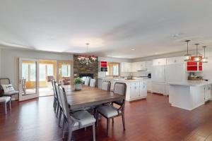 a kitchen and dining room with a wooden table and chairs at The 19th Hole Lakeside in Eagle River