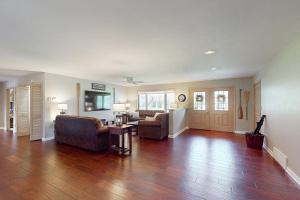 a living room with a couch and a table at The 19th Hole Lakeside in Eagle River
