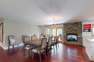 a dining room with a table and chairs and a fireplace at The 19th Hole Lakeside in Eagle River +40 photos