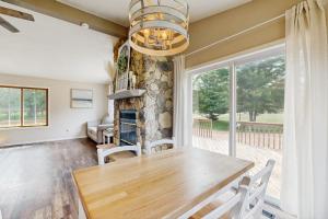 a dining room with a table and a fireplace at Rome Retreat- Steps from Beach & Golf in Nekoosa