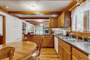 a kitchen with wooden cabinets and a wooden table at Rustic Woodland Retreat- Unit A in Arkdale