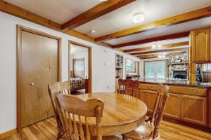 a kitchen and dining room with a wooden table and chairs at Rustic Woodland Retreat- Unit A in Arkdale
