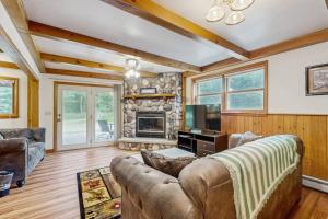 a living room with a couch and a fireplace at Rustic Woodland Retreat- Unit A in Arkdale