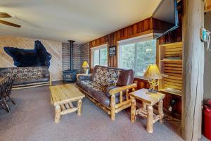a living room with a couch and a table at The View on Found Lake in Saint Germain