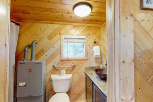 a bathroom with a toilet in a wooden cabin at The View on Found Lake in Saint Germain +13 photos