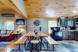 a kitchen with a wooden table in a cabin at The Korn Krib in Mercer