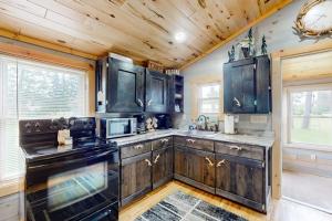 a kitchen with black appliances and wooden cabinets at The Korn Krib in Mercer +27 photos
