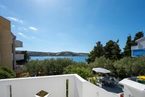 a view of the water from the balcony of a building at Apartments by the sea Stara Novalja, Pag - 6301 in Stara Novalja