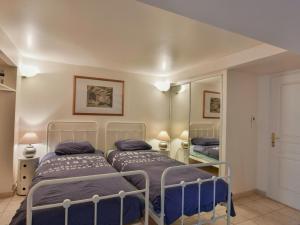 a bedroom with two beds and a mirror at Paulette in Éze +34 photos