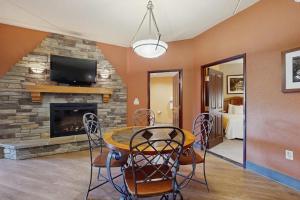 a living room with a table and a fireplace at Chula Vista Resort 2224 & 2226 in Wisconsin Dells