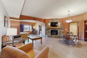 a living room with a couch a table and a fireplace at Chula Vista Resort 2224 & 2226 in Wisconsin Dells
