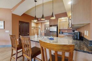 a kitchen with a large island with bar chairs at Chula Vista Resort 2224 & 2226 in Wisconsin Dells