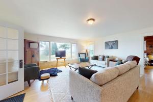 a living room with a couch and a tv at Flagpole Point in Phelps +38 photos