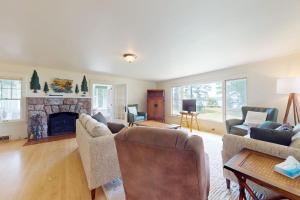 a living room with a couch and a fireplace at Flagpole Point in Phelps