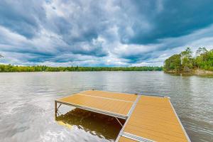 a wooden dock in the middle of a lake at Konkey's Kabin in Saint Germain