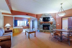 a living room with a couch a table and a fireplace at Chula Vista Condo #2402 in Wisconsin Dells