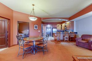 a dining room and kitchen with a table and chairs at Chula Vista Condo #2402 in Wisconsin Dells