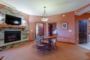 a dining room with a table and a fireplace at Chula Vista Condo #2402 in Wisconsin Dells