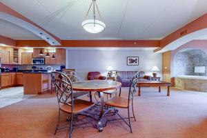 a kitchen and living room with a table and chairs at Chula Vista Condo #2402 in Wisconsin Dells