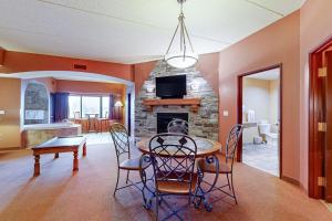 a dining room with a table and chairs and a fireplace at Chula Vista Condo #2402 in Wisconsin Dells +29 photos