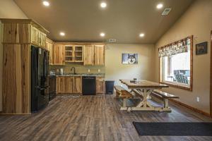 a kitchen with a table and a wooden floor at The Beaver in Conover