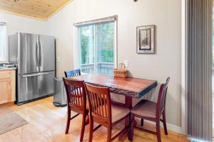 a kitchen with a table and chairs and a refrigerator at Hillis House in Arbor Vitae