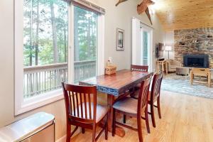 a dining room with a wooden table and chairs at Hillis House in Arbor Vitae +42 photos