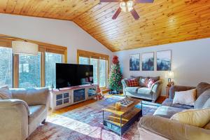 a living room with couches and a flat screen tv at Big St Germain Hideaway in Sayner +27 photos
