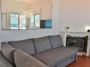 a living room with a couch and a fireplace at Paulette in Éze