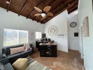 a living room with a couch and a ceiling fan at Casa Xantus in Toros Pintos