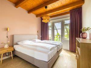 a bedroom with a large bed and a window at de Sedyk in Pietersbierum