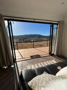 a living room with a couch and a large sliding glass door at Casa Xantus in Toros Pintos