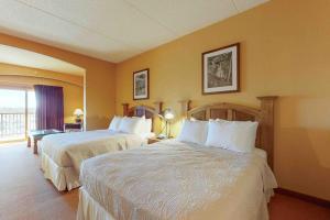 a hotel room with two beds and a balcony at Chula Vista Resort 2224 in Wisconsin Dells