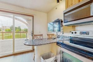 a kitchen with a counter with a stove top oven at Chula Vista Resort Villa # 7212 in Wisconsin Dells
