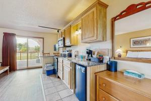a kitchen with wooden cabinets and a counter top at Chula Vista Resort Villa # 7212 in Wisconsin Dells