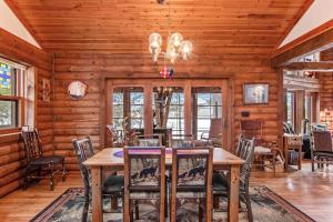 a dining room with a table and chairs at Sailor's Point Lodge in Eagle River