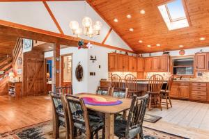 a dining room and kitchen with a table and chairs at Sailor's Point Lodge in Eagle River +27 photos
