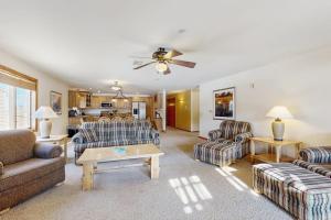 a living room with two couches and a table at Sunset Condominiums: Golf View in Arkdale