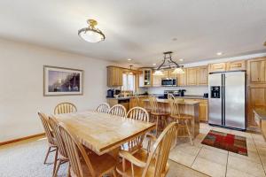 a kitchen with a wooden table and a refrigerator at Sunset Condominiums: Golf View in Arkdale