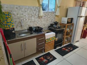 a small kitchen with a sink and a stove at Aconchego da Kika in Caruaru +22 photos