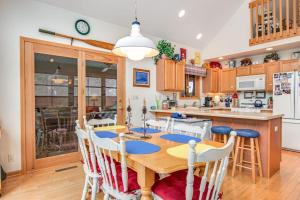 a kitchen with a wooden table and chairs at RTLCMP Lakehouse in Arbor Vitae +36 photos
