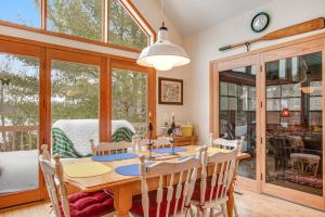 a dining room with a wooden table and chairs at RTLCMP Lakehouse in Arbor Vitae