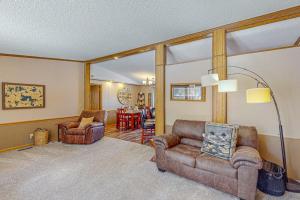 a living room with a couch and chairs and a table at Thoro Cottage in Minocqua
