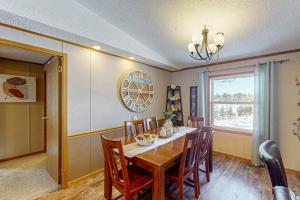 a dining room with a table and chairs and a window at Thoro Cottage in Minocqua