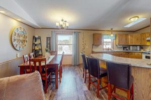 a kitchen with a table and chairs and a counter at Thoro Cottage in Minocqua