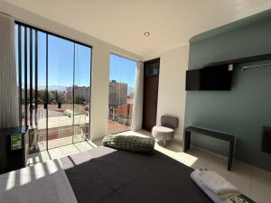 a bedroom with a large window with a view at Forty 125 in Tarija