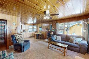 a living room with a couch and a table at Chickadee Cabin in Saint Germain