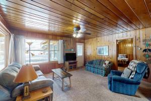 a living room with a couch and a tv at Chickadee Cabin in Saint Germain