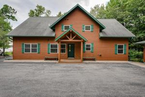 a large wooden house with a driveway in front of it at Island View I in Eagle River