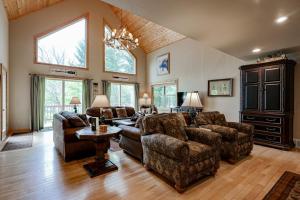 a large living room with couches and a chandelier at Island View I in Eagle River +42 photos